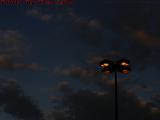 Parking Lot Lamps Igniting in Dusk Light