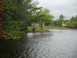 Idle Canoe at Lake's Edge Under Cloudy Skies, Plantation